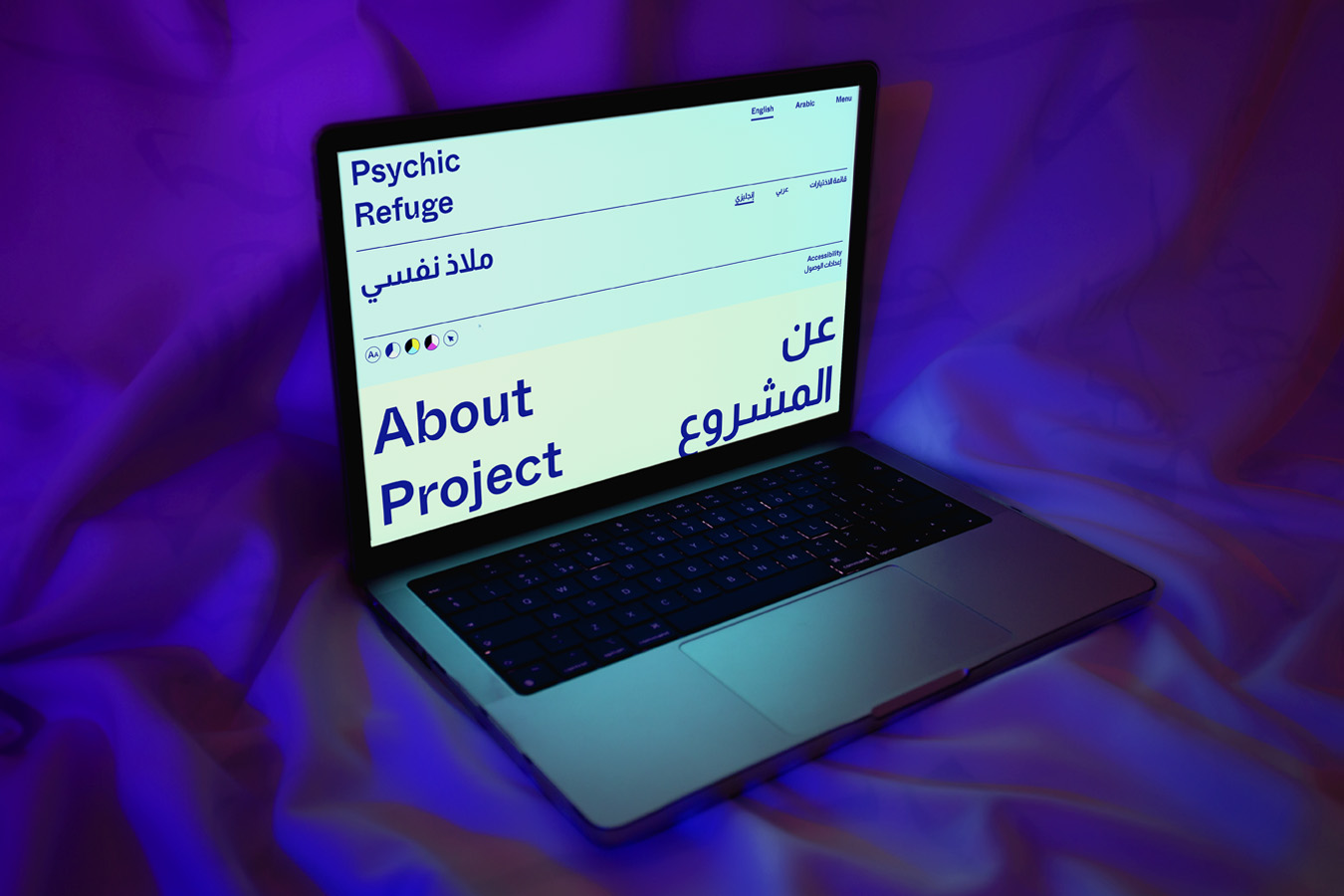alt: Image shows a laptop on a purple fabric, on the laptops screen is the Psychic Refuge website homepage