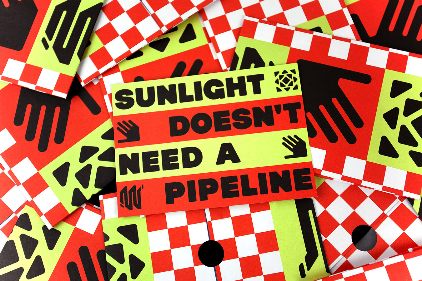 A pile of Sunlight Doesn't Need a Pipeline Postcards and fold out posters.