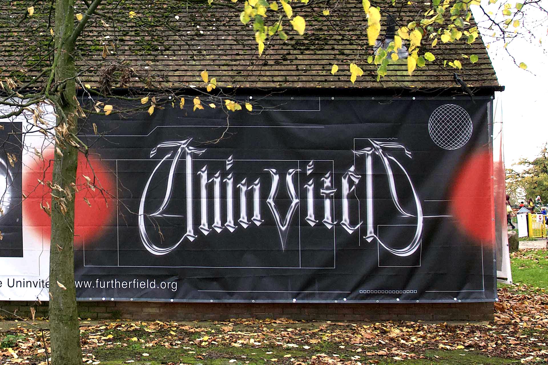 a black hoarding with a chromatic uninvited logo
